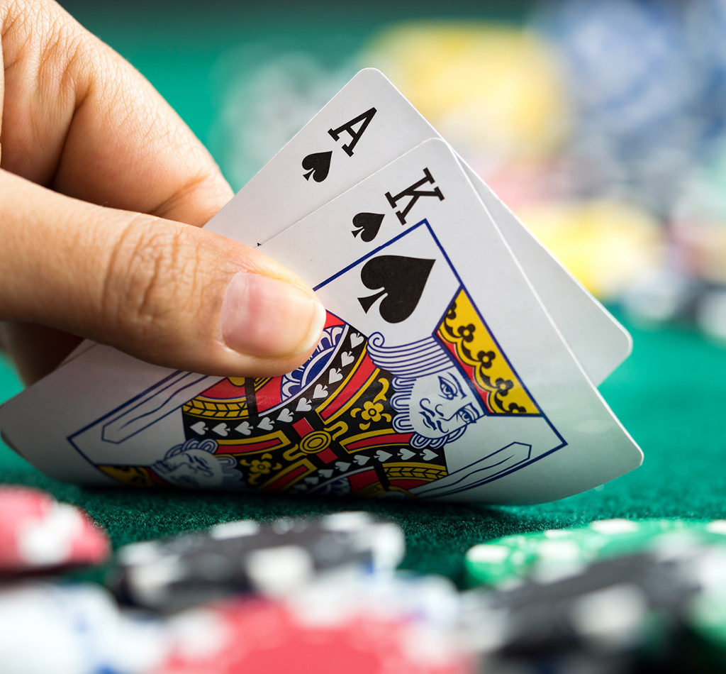 Gambling hand holding two playing cards.